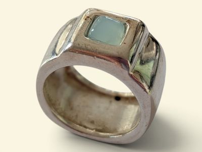 sterling silver ring with a green stone in the center