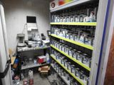 many cans of paint on the shelves in the room