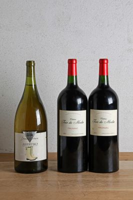 three bottles of wine sitting on a table next to each other