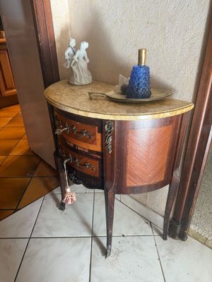 a small table with a blue vase on top of it