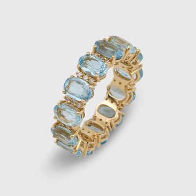 a gold ring with blue topaz and white topaz stones