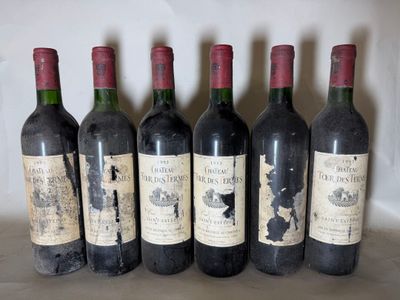 six bottles of wine are lined up in a row on a table