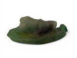 a statue of a person laying down on a leaf
