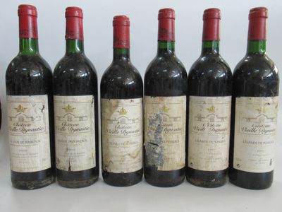 six bouteilles de vin sont alignées sur une table