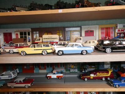 many toy cars on a shelf in a toy store