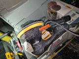 a box with a sander and other tools inside of it