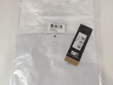 a plastic bag with a white t - shirt on top of it