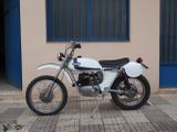 a white motorcycle parked in front of a building