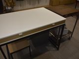 a white table with a wooden top in a room