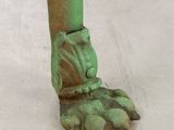an image of a close up of a foot with a green cast iron foot