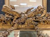a gold frame with a picture of a bird on it