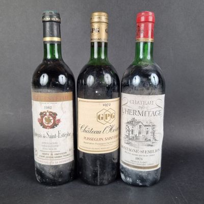 three bottles of wine sitting on top of a table next to each other