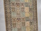 a rug hanging on the wall next to a chair