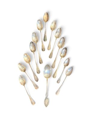 a lot of spoons arranged in a circle on a white surface