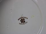 a white plate with a brown and black design on it