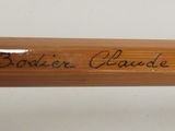 a wooden baseball bat with writing on it on a table
