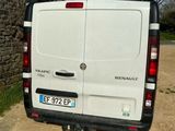 a white van parked in front of a stone building