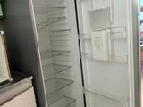 an open refrigerator in a kitchen with a door open