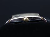 a close up of a watch on a black surface