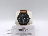 a black watch with a brown leather strap on it