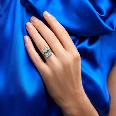 the woman is wearing a blue dress and a diamond ring