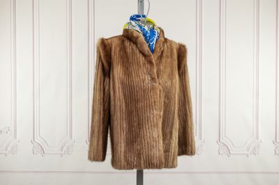 an image of a brown fur coat on a mannequin stand