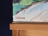 a picture of a painting on a easel that is on a table