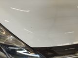 a close up of a car ' s headlight on a white car