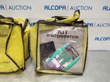 two bags with items in them sitting on a table in front of a wall
