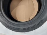 tires are stacked on top of each other on a white surface