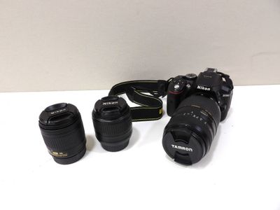 three cameras sitting on a table next to each other