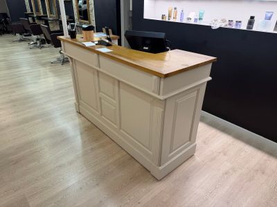 an image of a hair salon with a desk and chairs