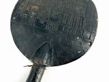 a black object with a metal handle on a white surface