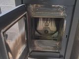 a small stove that is in the corner of a room