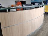 an image of a reception area with a desk and chairs