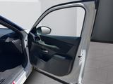 a white car with its door open on a tiled floor