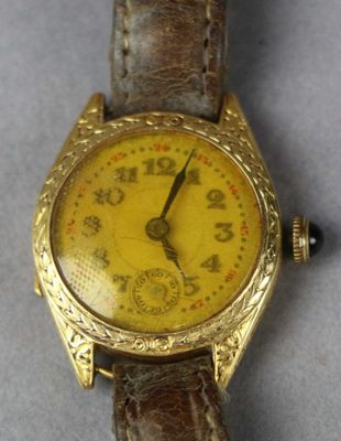 an image of a close up of a wrist watch on a table