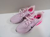 pink and black nike running shoes with pink laces on a white surface