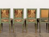 six green chairs with floral upholstered seats in a room