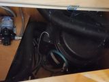a sink that has a bunch of pipes and wires in it