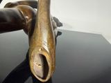 a bronze statue of a person laying on a black table