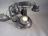 a black telephone that is sitting on a table