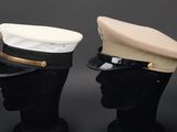 pair of hats on mannequin heads on a black background