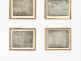 several pieces of artwork are hanging on a wall in a room