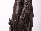 an image of a statue of a woman holding a book