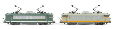 two trains that are sitting side by side on a white surface