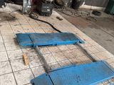 a blue piece of equipment on the floor in the garage