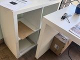 a white desk with a computer on it in a room