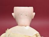 a small doll with a bandage on it ' s back