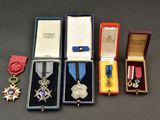 several medals and medals are displayed in a box on a table